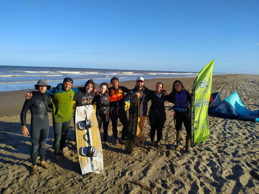 EK Experience crew on the beach holding their kiteboards